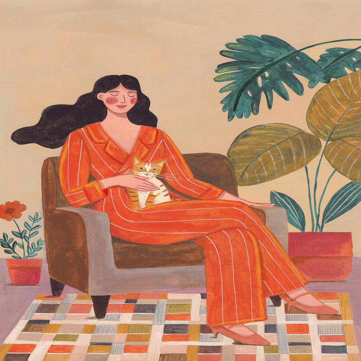 Woman with cat in living room with warm earth tones